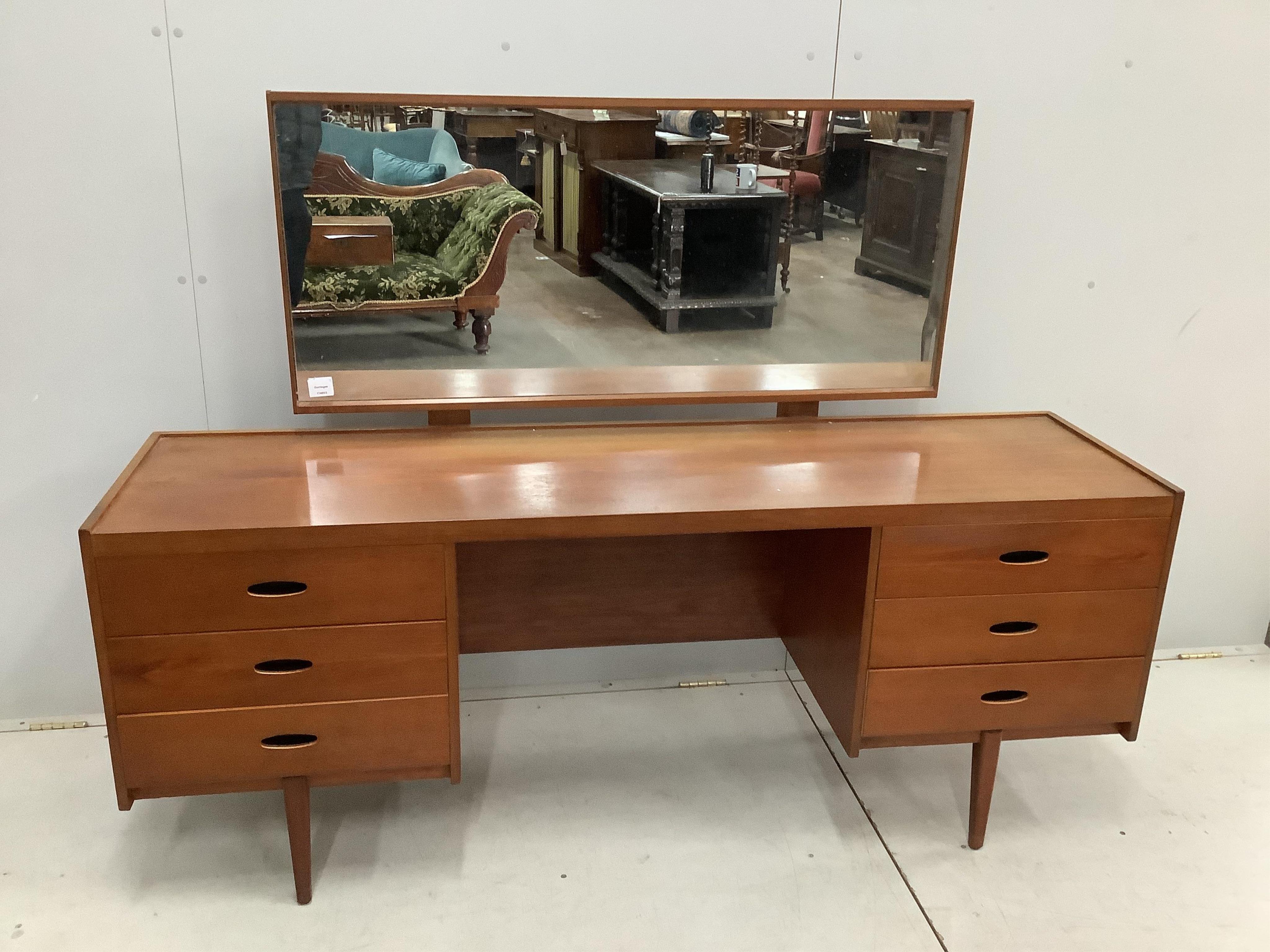 An Austin Suite teak dressing table, width 168cm, depth 44cm, height 126cm